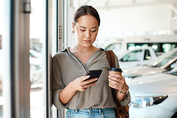 Image showing Cellphone, coffee and female person in a showroom typing a text message or scrolling on social media. Communication, technology and woman browsing on a mobile app with a cellphone at a car dealership