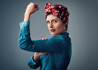 Image showing Flexing, strong and portrait of a pinup girl with muscle in studio for support, women power and fashion. Female person show bicep on grey background for motivation, freedom and retro or vintage style