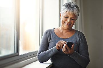 Image showing Window, smile and senior woman with a smartphone, connection and social media at home. Mature female, person and old lady with a cellphone, email and mobile app with network, happiness and typing