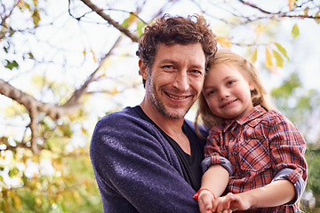 Image showing Happy, love and portrait of father and daughter in backyard garden for hugging, bonding or affectionate. Happiness, relax and family with man and young girl in outdoors for embrace, autumn and care