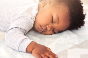 Image showing Baby, african and boy sleeping on bed for rest, health and peace for growth, development and relax in family home. Black male infant, tired and sleep in bedroom with fatigue, quiet and calm in house