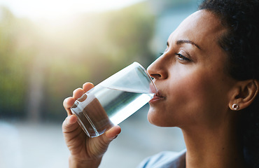 Image showing Health, glass and woman drinking water, wellness and nutrition at home, happiness and refreshment. Female person, happy and lady with clear liquid, natural and care with a smile, fresh and hydration