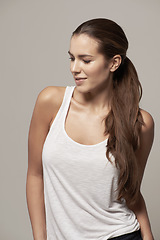 Image showing Fashion, casual and profile of a woman in a studio with a trendy, stylish and apparel outfit. Happy, smile and female model with cool style, long hair and positive mindset isolated by gray background