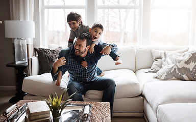 Image showing Father, boy children and playing in living room, fun and carefree with love, energy and happy at family home. Man play with kids on sofa, crazy and playful with piggyback and excited with laughter