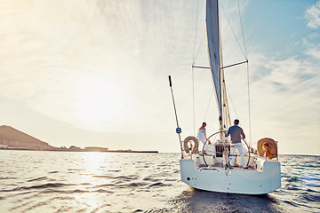 Image showing Couple, yacht or sailing on vacation for adventure at sea with sun and waves to relax in summer. Ocean, people or cruise together for holiday on water for travel and sunshine for retirement lifestyle