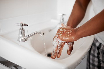 Image showing Clean, hygiene and person washing hands in the bathroom with soap for wellness, health and bacteria prevention. Protection, home and man cleaning hand with water in his apartment as morning routine