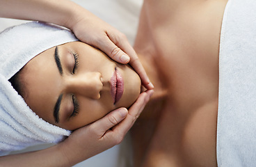 Image showing Woman, hands and face in relax for massage, skincare or beauty spa treatment on bed above at resort. Top view of female relaxing with eyes closed for calm therapy, healthy wellness or cosmetic facial