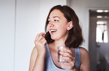 Image showing Healthcare, medication and woman drinking a pill with a glass water for wellness at her home. Medicine, medical and happy female person taking a vitamin, supplement or tablet with liquid in apartment