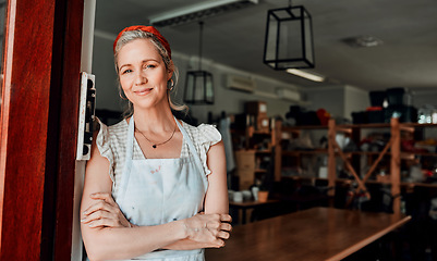 Image showing Happy woman, portrait and arms crossed in small business confidence at entrance for workshop in retail store. Confident female person, ceramic designer or owner smiling for craft or creative startup