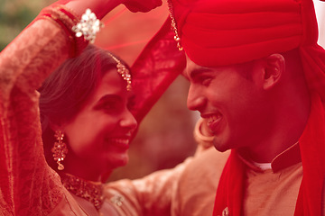 Image showing Wedding, romance and red veil with a couple together in celebration of love at a ceremony. Happy, marriage or islam with a hindu bride and groom getting married outdoor in tradition of their culture