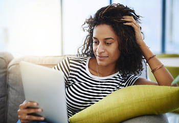 Image showing Relax, tablet and woman on sofa in home for network, online website and social media. Communication, mobile app and African female person on digital tech for streaming, videos and internet connection