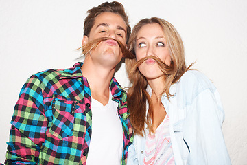 Image showing Quirky, portrait and couple with hair moustaches being funny, comic and playful together in a studio. Crazy, young and a man and woman being silly and goofy on a date isolated on a white background