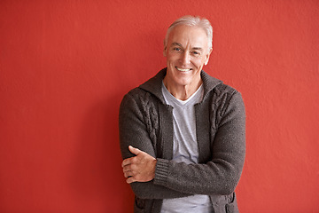 Image showing Happy senior man, portrait and red background in retirement with smile, arms crossed and fashion. Elderly guy, happiness and confidence by wall with excited face for lifestyle, experience and relax