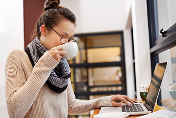 Image showing Remote work, woman drinking coffee and laptop for freelance writer at cafe store. Social media or networking, reading emails and female student or content creator on mobile device in restaurant