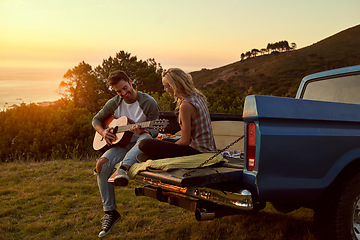 Image showing Sunset, truck or couple with guitar in nature on romantic holiday vacation for bonding or relaxing on date. Car road trip, travel or people playing music in summer with romance in park field together