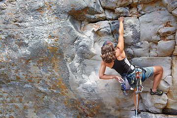 Image showing Rock climbing, fitness and challenge with woman on mountain for adventure and travel with space. Strong, freedom and hiking with female climber training in nature for courage, safety and workout