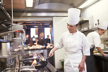 Image showing Chef, woman and frying in restaurant kitchen, catering service and prepare food for fine dining. Professional, cooking and female person saute meat with cook pan making meal nutrition for hospitality