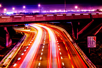 Image showing Night lights, city and highway with driving infrastructure in cape town with road travel development. Transportation, neon lighting and urban street in the evening and dark in Africa rush and blur