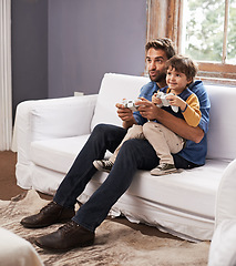 Image showing Love, father and son on a couch, video game and bonding at home, happiness and relax together. Family, dad and boy with parent, kid and male child playing online, smile and loving with cyber gamer