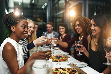 Image showing Food, party and wine with friends at restaurant for celebration, pizza and social event. Happy, diversity and toast with group of people eating together for fine dining, cheers and free time