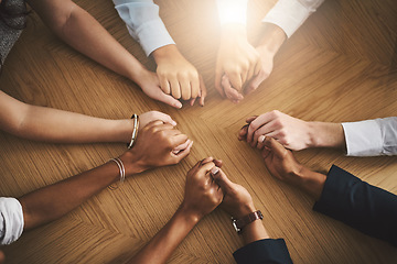 Image showing Support, diversity and people holding hands by a table at a group counseling or therapy session. Gratitude, trust and friends in a circle for praying together for religion, community and connection.