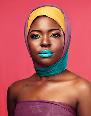 Image showing Bold makeup, headwrap and portrait of a black woman isolated on a pink background in a studio. Bright, color and headshot of an African model with headwear and cosmetics for culture and lifestyle