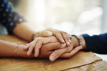 Image showing Holding hands, support and closeup with trust, solidarity and community on a home table. Therapy, diversity and gratitude of friends together with hope, respect and love for grief empathy and forgive