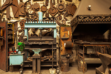 Image showing Metal, workshop and industrial factory with retro steel and blacksmith shop with no people. Manufacturing, iron workspace and artisan industry with tools, workplace equipment and warehouse with craft