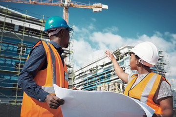 Image showing Blueprint, engineer or architect team talking outdoor about building project, construction or architecture. Black woman manager and man together for engineering, planning or safety discussion in city