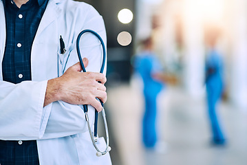 Image showing Medical, crossed arms and closeup of a doctor with a stethoscope in a hospital with mockup space. Career, professional and zoom of a male healthcare worker hand with equipment in a medicare clinic.