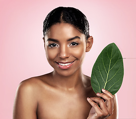 Image showing Portrait, face and happy woman with leaf for skincare in studio, pink background and organic dermatology. African model, leaves and eco friendly beauty, natural shine and sustainable plant cosmetics