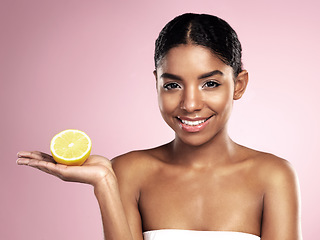 Image showing Lemon fruit, skincare and portrait of happy woman in studio mockup, pink background and vitamin c benefits. Face of african model, citrus and natural beauty for cosmetics, vegan dermatology and shine