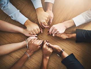 Image showing Circle, solidarity and people holding hands by table at group counseling or therapy session. Gratitude, trust and friends with intimate moment for prayer together for religion, unity and connection.