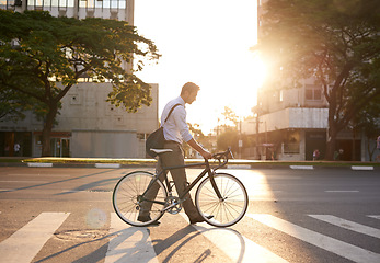 Image showing Commute, bike and business man in city for morning, travel and carbon footprint. Cycling, transportation and urban with male employee walking on crosswalk for journey, transit and professional