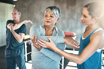 Image showing Stretching, physiotherapy and old woman with personal trainer for fitness, wellness or rehabilitation. Health, workout or retirement with senior patient and female trainer in gym for warm up training