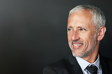 Image showing Businessman, thinking and happy with a smile on face with idea and space for mockup in studio. Headshot of a senior entrepreneur person on a black background for corporate vision and career pride
