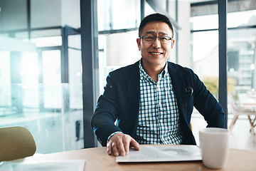 Image showing Portrait, tablet and data with a business man in the office, sitting at a desk for planning or research. Happy, mindset and professional with a mature asian male manager working on his company vision