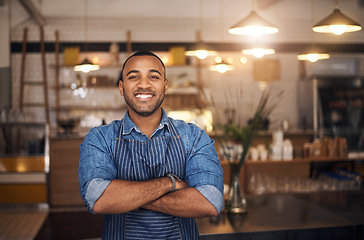 Image showing Coffee shop, waiter and portrait of African man in restaurant for service, working and crossed arms in cafe. Small business owner, bistro startup and male barista smile in cafeteria ready to serve