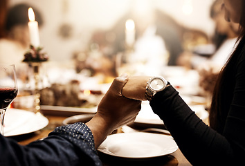 Image showing Prayer, food and hand holding with family at table in dining room for holiday, thanksgiving or worship. Celebration, support and gratitude with closeup of people at home for kindness, dinner and love