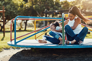 Image showing Mother with daughter laughing, together on roundabout at park and playing with fun outdoor. Love, care and bonding with family happiness, woman and girl enjoying time at playground with freedom