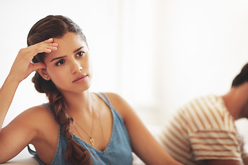 Image showing Unhappy, conflict or sad with a couple fighting on a sofa in their home living room about an affair or breakup. Depression, abuse or domestic violence with a woman thinking of breakup while arguing