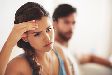 Image showing Unhappy, upset or conflict with a couple arguing about an affair or breakup on their home living room sofa. Depression, abuse or domestic violence with a sad woman thinking of divorce after a fight