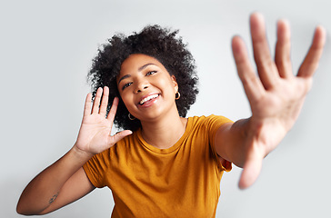 Image showing Portrait, young woman and posing with hand on ear gesture smiling or being cheerful with wide open palm on grey studio background. Model, natural and pose for happiness or excitement