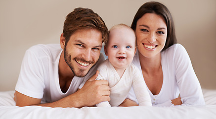 Image showing Happy portrait, dad and mom of baby kid on bed for love, care and quality time together to relax at home. Smile of family, parents and cute newborn child for development, caring support and happiness