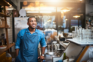 Image showing Coffee shop, barista and happy black man in restaurant for service, working and thinking in cafe. Small business owner, bistro startup and male entrepreneur smile in cafeteria counter ready to serve