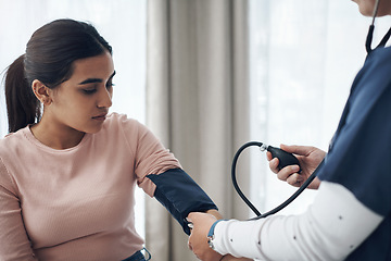 Image showing Blood pressure, woman and health test with support at a clinic and healthcare hospital with doctor. Monitor, checking and nurse with young female patient at a wellness and medical consultation