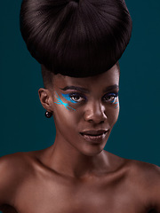 Image showing Portrait, hair care and makeup with a model black woman in studio on a blue background for beauty. Face, hairstyle and cosmetics with a beautiful young female person at a salon for fashion or styling