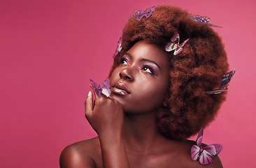 Image showing Cosmetic, makeup and black woman with butterflies in a studio with beauty, natural and elegant face. Cosmetics, fantasy and young African female model posing with beautiful insects by pink background