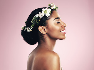 Image showing Woman, smile and beauty of flower crown in studio, pink background and spring aesthetic. Face of happy african model, natural skincare and floral hair wreath for vegan cosmetics, makeup and shine