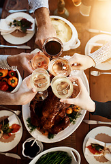 Image showing Wine, food and hands of people toast to celebrate at table for holiday, Christmas or thanksgiving dinner party. Above group of family or friends with drinks for cheers while eating lunch or dinner